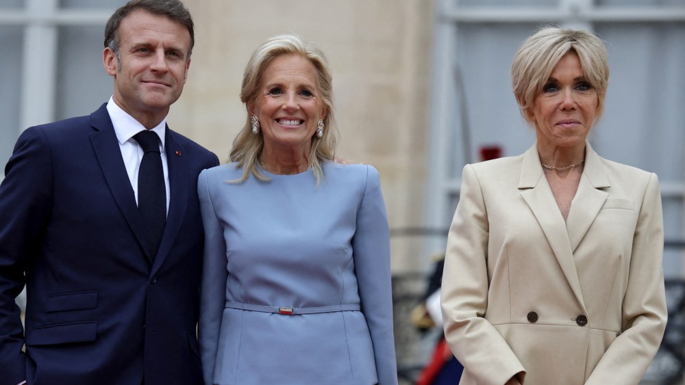 French President Emmanuel Macron (L) and his wife Brigitte Macron (R) greet U.S. first lady Jill Biden (C) on arrival ahead of a reception for heads of state and governments ahead of the opening ceremony of the Paris 2024 Olympic Games.