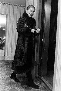 Opera singer Maria Callas, wearing a black midi dress and fur coat after an outfit change, poses for portraits during an interview as she prepares for a dinner party on November 21, 1970 in New York City.