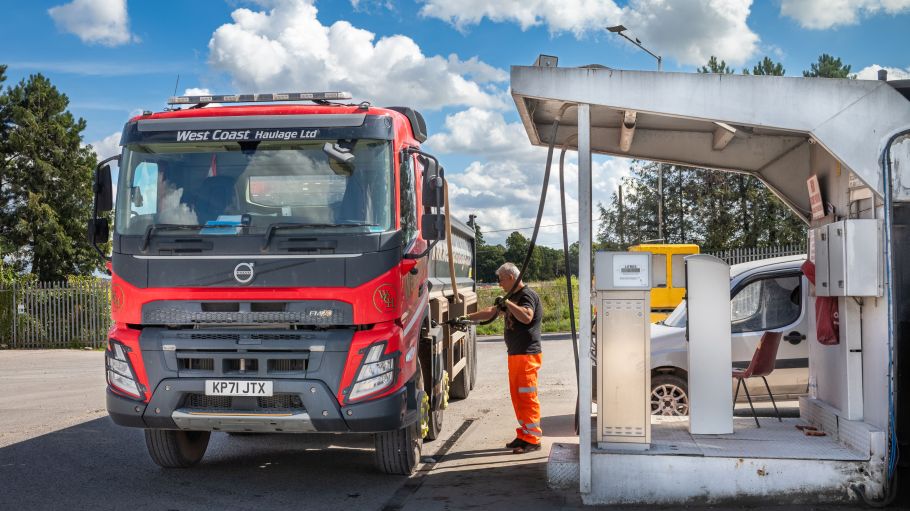 Truck driver fills his tank with diesel fuel.