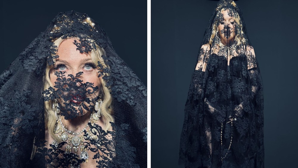 Madonna wore a chiffon and long lace slip dress with high slit from FW24/25 runway show and worn over a black corset. She adorned the look with a Chantilly long lace black veil, an Alta Gioielleria necklace in yellow and white gold with diamonds and Bianco d’Istria stone carved skulls, a gold and crystal crown. She accessorized her look with a black devotion bag, madonna at the Dolce & Gabbana spring 2025 Women’s ready to wear Runway Show during Milan Fashion Week