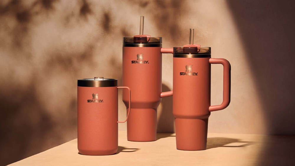 three orange cups on a beige tavke