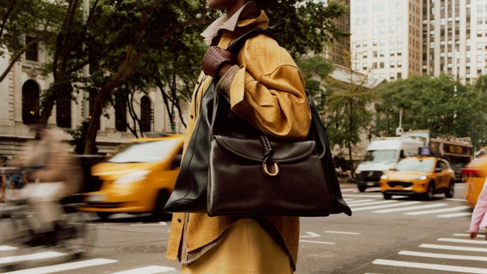model wearing Bottega Veneta leather bags, cotton shirts, suede skirt and leather gloves in New York City