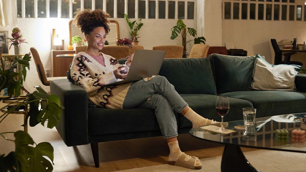 woman sitting with legs crossed on sofa in a living room