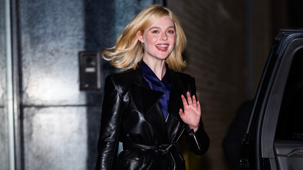 Elle Fanning street style khaite coat waves while wearing a leather trench coat,  Elle Fanning is seen in Tribeca on November 23, 2024 in New York City.