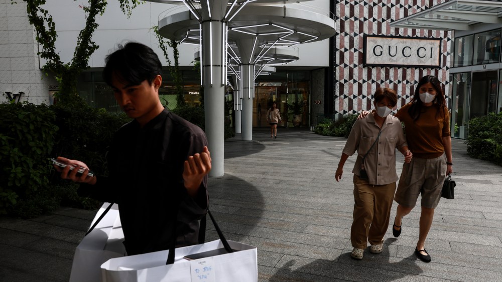 Chinese shoppers walk past a Gucci store when shopping abroad during China's Golden Week holiday this October.