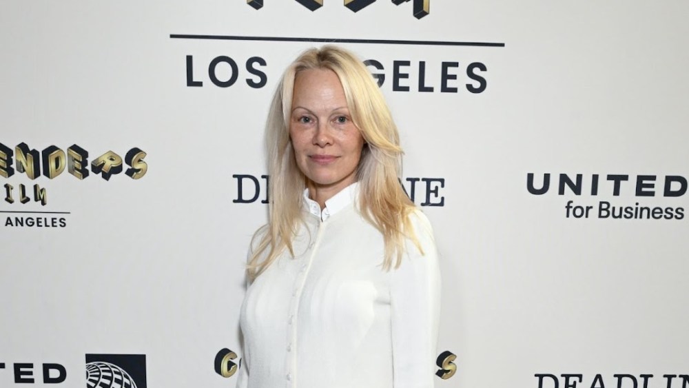 Pamela Anderson wears a white shirt.