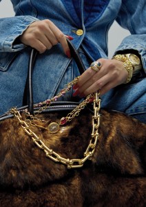 Schiaparelli denim blazer and jeans; Acne Studios Bowlina fur bag; Tiffany & Co. Tiffany HardWear Bold Graduated Link Necklace in yellow gold; Micah Antoni 18-karat gold and mother-of-pearl cuff; Hooradorf Pegasus necklace with Corinthian coin, pair of oval rubellite cabochons, pair of oval pink tourmaline cabochons satin-finished 22-karat yellow gold chain.Movado Gold Heritage Series Ondoplan watch; Marina B Onda Toi and Moi Ring in 18-karat yellow gold with blue topaz and pavé diamonds photographed in New York, New York on November 19th, 2024.