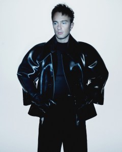 Saint Laurent by Anthony Vaccarello rubber jacket, silk crepe wide leg trousers and shoes. Celine Homme by Hedi Slimane wool triomphe high collar sweater.