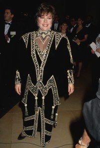 Kathy Bates, wearing a black-and-gold outfit, attend the 48th Golden Globe Awards, held at the Beverly Hilton Hotel in Beverly Hills, California, 19th January 1991.