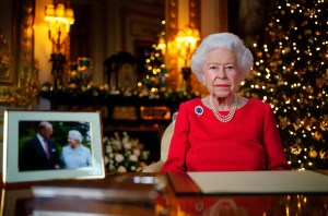 Queen Elizabeth II records her annual Christmas broadcast in the White Drawing Room at Windsor Castle on December 23, 2021 in Windsor, England. The photograph on the desk is of The Queen and the Duke of Edinburgh, taken in 2007 at Broadlands, Hampshire, to mark their Diamond Wedding Anniversary.