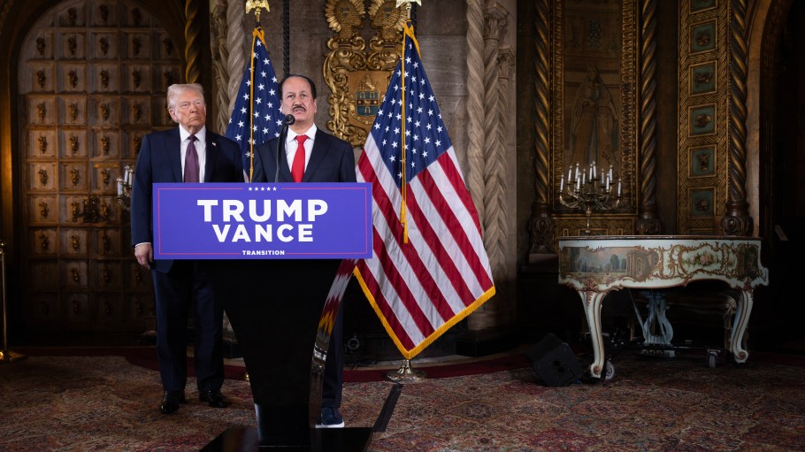 U.S. President-elect Donald Trump stands behind DAMAC Properties CEO Hussain Sajwani at Mar-a-Lago.