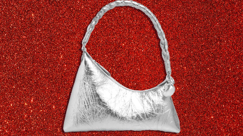 metallic aupen handbag over sparkly red background
