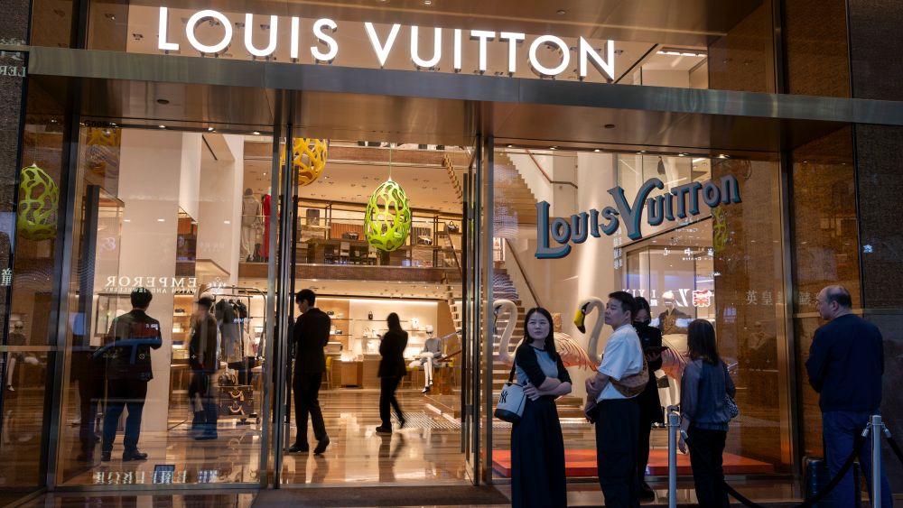 Shoppers in front of a Louis Vuitton store in Hong Kong.