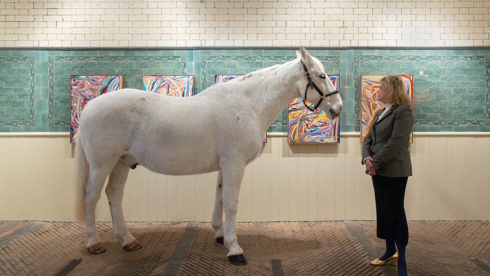 Artist Tanya Ling with a gray gelding called Banner at the opening of "Incitatus" at Lyndsey Ingram in London.