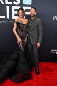 Chrissy Teigen in Christian Siriano with John Legend in Louis Vuitton