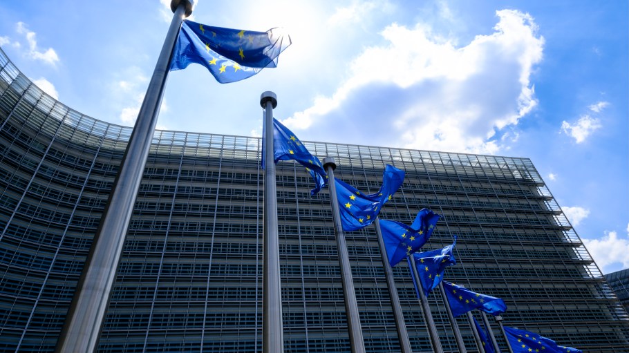The EU flags flutter in the wind in front of the Berlaymont, the EU Commission headquarter in Brussels, Belgium.