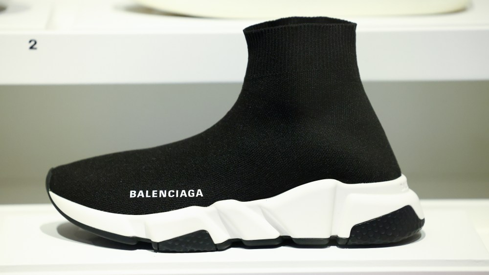 PARIS, FRANCE - FEBRUARY 06: A close-up on a Balenciaga speed trainers sneaker (2017) during the "La Mode En Mouvement #3 - Fashion On the Move #3" Exhibition at Palais Galliera on February 06, 2025 in Paris, France. From 8 February to 12 October 2025, the Palais Galliera presents more than 180 new items from the museum's collections and one of the looks from the Paris 2024 Olympic Games opening ceremony: the rider armor. This outfit created by Jeanne Friot in collaboration with leather artisan Robert Mercier is a hooded removable cuirass, a braconnière (hip armor), a bodysuit, leggings, gloves, and thigh-high boots. (Photo by Marc Piasecki/Getty Images)