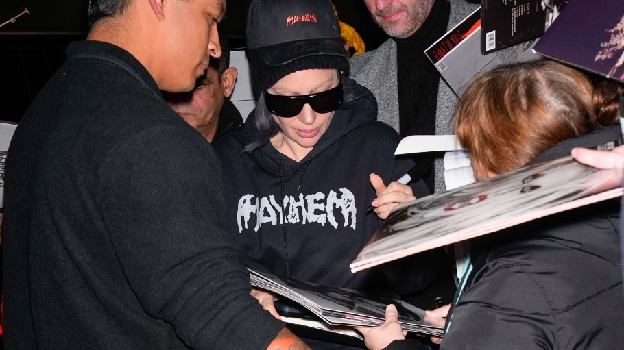 Lady Gaga signs fans' items in New York City.