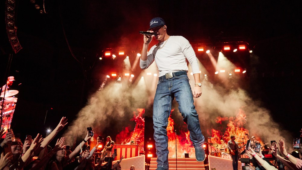 Parker McCollum in a Lucchese hat on stage.