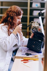 Restoring a vintage Chanel bag at the “Chanel & moi” repair workshop at the AVH factory.