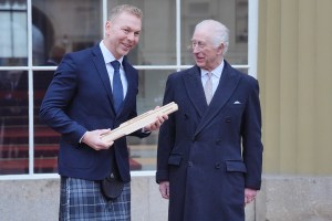 LONDON, ENGLAND - MARCH 10: King Charles III with Sir Chris Hoy during the  launch of the Commonwealth Sport King's Baton Relay, officially starting the countdown towards the Glasgow 2026 Commonwealth Games at Buckingham Palace on March 10, 2025 in London, England. (Photo by Jonathan Brady - WPA Pool/Getty Images)