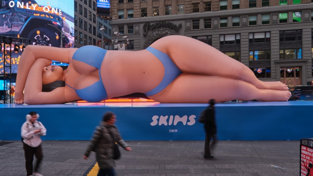 An installation of Kim Kardashian wearing a blue swimsuit featured in New York City's Times Square.