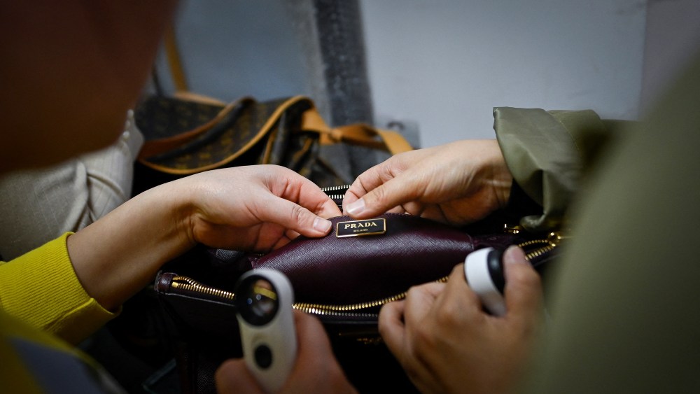 This picture taken on March 24, 2021 shows trainees practicing methods in verifying the authenticity of a handbag following a class at the Extraordinary Luxuries Business School in Beijing. - It's the world's biggest market for luxury goods -- and their counterfeit equivalents -- so an expert eye for telling a bona fide Chanel hand bag from a bogus one is a skill set in hot demand across China.  
 - TO GO WITH CHINA-ECONOMY-LUXURY-FAKES,FOCUS BY HELEN ROXBURGH (Photo by WANG ZHAO / AFP) / TO GO WITH CHINA-ECONOMY-LUXURY-FAKES,FOCUS BY HELEN ROXBURGH (Photo by WANG ZHAO/AFP via Getty Images)