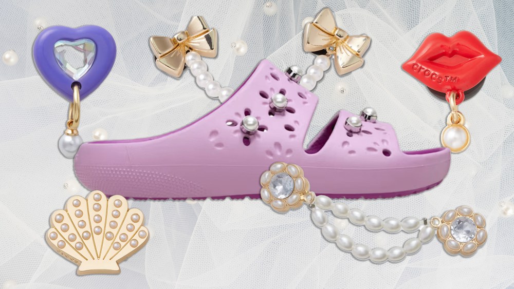 purple-hued crocs sandal on a lace and pearl background next to a selection of pearl charms from crocs