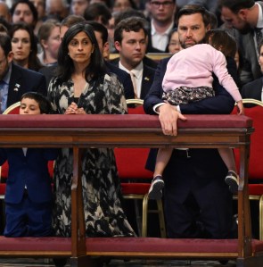 VATICAN CITY, VATICAN - APRIL 18: U.S. Vice President JD Vance holds his daughter Mirabel next to his wife Usha Vance as they attend Good Friday mass in St. Peter's Basilica at the Vatican on April 18, 2025 in Vatican City, Vatican.  Vance is traveling to Italy and India through next week. He is scheduled to meet with Italian Prime Minister Giorgia Meloni in Rome before making his first visit to India. (Photo by Kenny Holston - Pool/Getty Images)