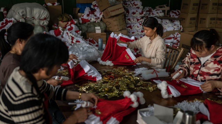 Workers near Yiwu, Zhejiang Province in China make red Santa Claus hats for export at a factory on April 28.