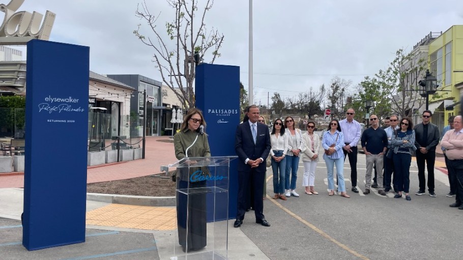 Elyse Walker, backed by Rick Caruso, spoke at a press conference at the Palisades Village on Wednesday.