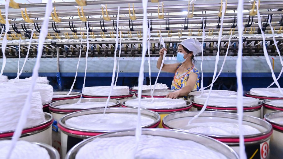 An employee works on a production line at a textile factory in China.