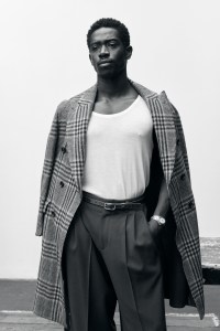 Cesare Attolini cashmere double fabric coat; Hanro cotton tank top; Lanvin wool-woven pleated trousers; Amiri belt; IWC Ingenieur Automatic 35 watch with gold case; all jewelry by Didris.