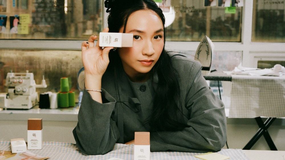 Sandy Liang for Beauty of Joseon holding a sunscreen.
