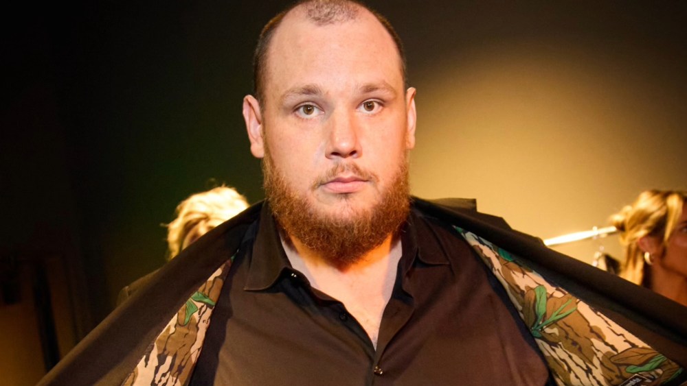 Luke Combs shows off the lining of his custom suit with camouflage lining.
