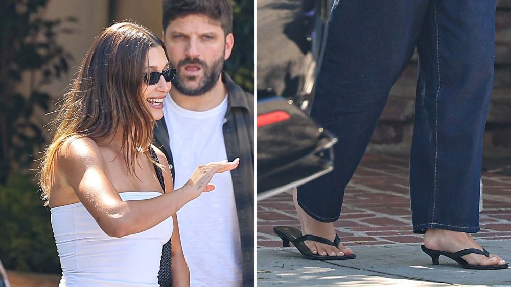 Hailey Bieber wears Toteme black leather heeled flip-flops with Gap denim while out in West Hollywood on Wednesday.