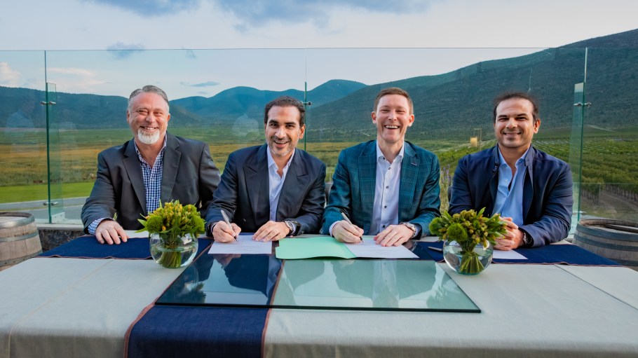 Cone and Artistic Milliners leadership sign acquisition documents.