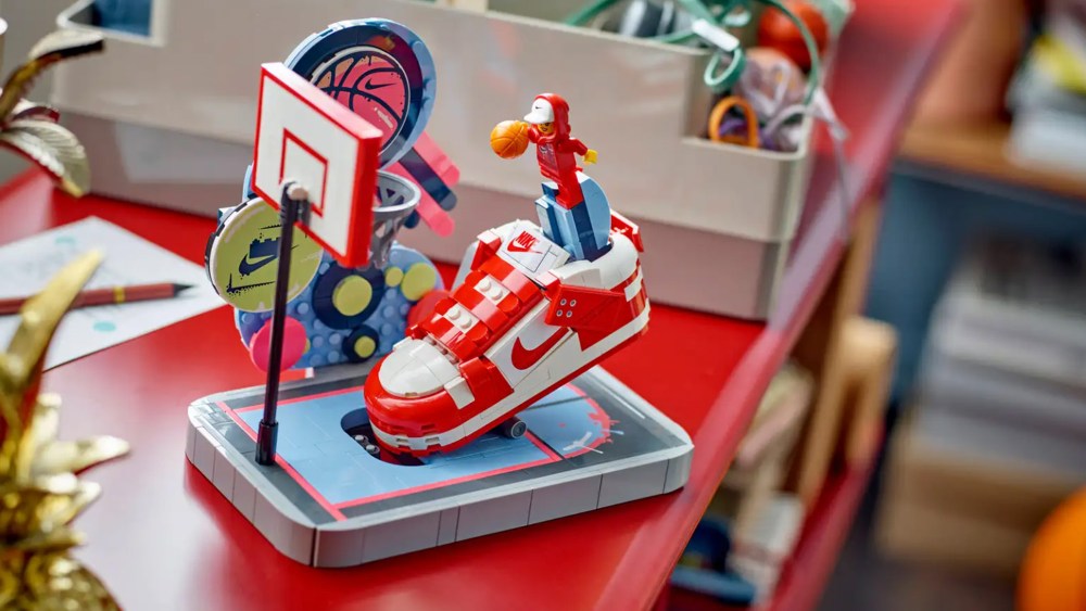 nike and lego's construction set, featuring a nike dunk sneaker, a figurine in a hoodie, and a basketball net