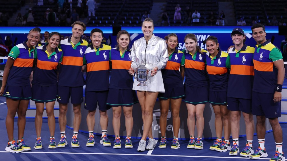 Aryna Sabalenka, wearing her Nike Tennis kit, poses with her trophy and the ball kids, dressed in Ralph Lauren, after defeating Amanda Anisimova during their Women's Singles Final match at the U.S. Open on Sept. 6, 2025 in New York City.