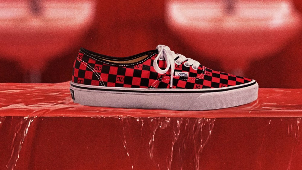 valentino x vans collaboration skate shoe in a black and red checkered print, resting on what looks like a red marble slab