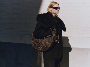 Schiaparelli calfskin Soufflé bag with studs, wool jacket and cowboy pants; Chimi sunglasses; Dior boots; Thomasine lambskin gloves.