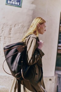 Louis Vuitton calfskin Express Travel bag; Dior embroidered trenchcoat; David Yurman gold cable hoop earrings.