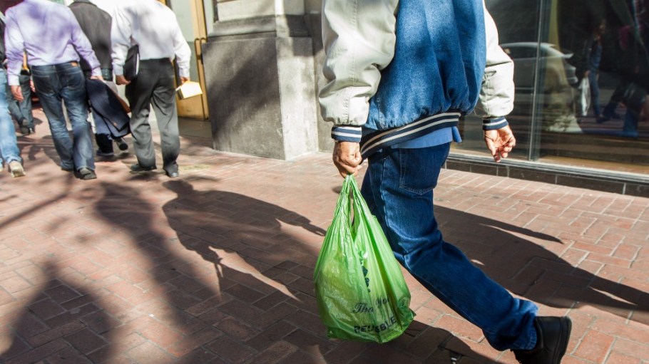 A shopper carrying a plastic bag in San Francisco.