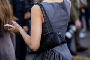PARIS, FRANCE - MARCH 05: A guest wears grey ruffled asymmetric top, Alaia teckel bag outside Cecilie Bahnsen during the Womenswear Fall/Winter 2025/2026 as part of Paris Fashion Week on March 05, 2025 in Paris, France. (Photo by Christian Vierig/Getty Images)