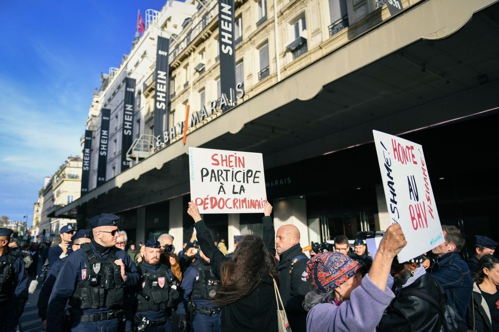 PARIS, FRANCE - NOVEMBER 5: Demonstrators protest against Shein brand's inauguration at the BHV Marais, in front of the BHV in Paris, France on November 5, 2025. (Photo by Firas Abdullah/Anadolu via Getty Images)