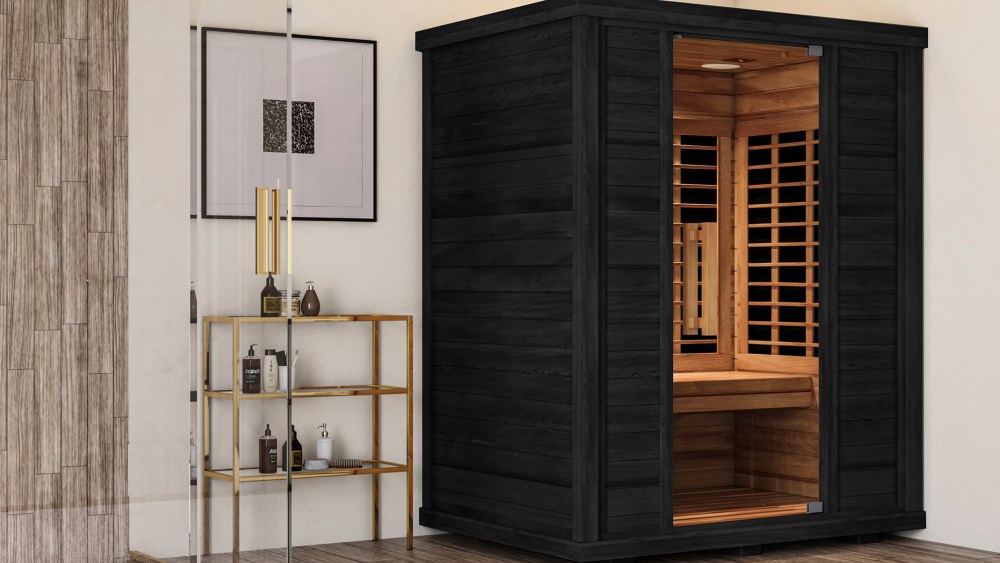 sun home saunas indoor home sauna in dark wood, standing next to a cabinet with bottles on it