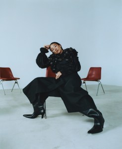 Noir Kei Ninomiya faux leather harness and polyester shirt; Issey Miyake wool pants; Balenciaga boots; Tiffany & Co. Bird on a Rock diamond earrings in platinum and gold and ring with rubellite and rubies.