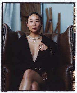 Givenchy by Sarah Burton wool coat; Tiffany & Co. Bird on a Rock by Tiffany Wings pavé diamond necklace in platinum with diamonds and Bird pendant in platinum and gold; Two Tiffany & Co. Bird on a Rock by Tiffany Wings diamond rings in platinum.