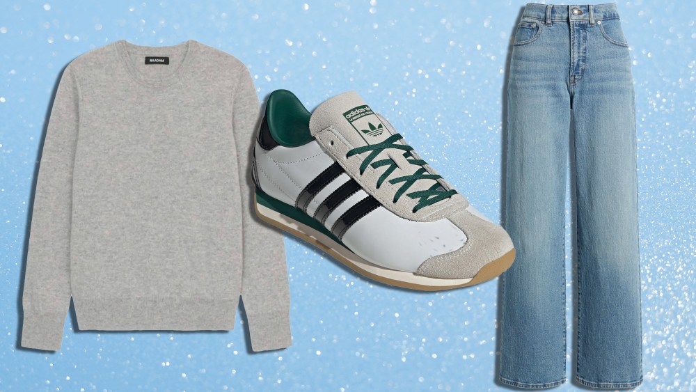 a cashmere sweater, adidas sneaker, and pair of jeans over a sparkly blue background