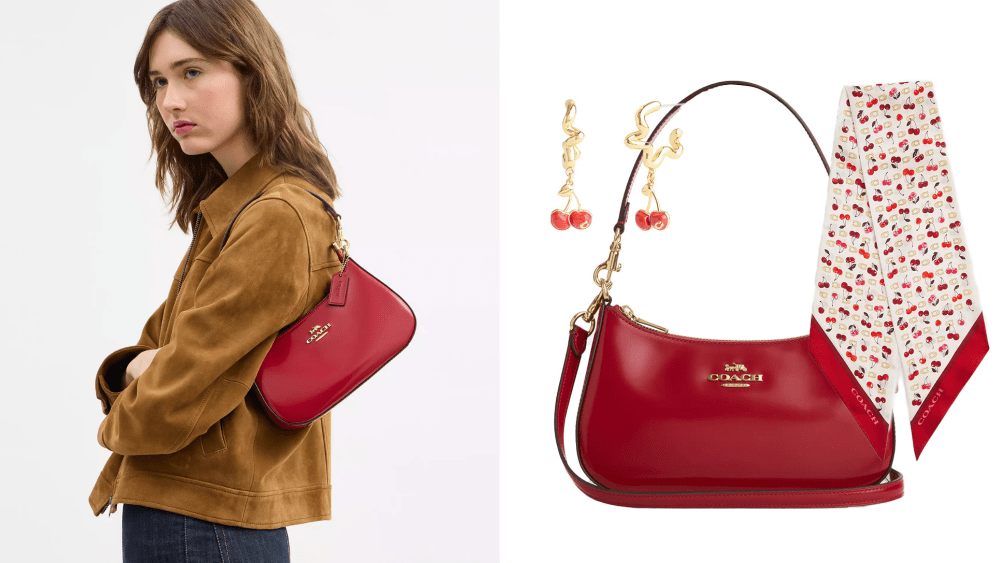a model looking to the side while carrying a red handbag from coach outlet; red coach outlet bag, cherry earrings, and coach cherry scarf over white background